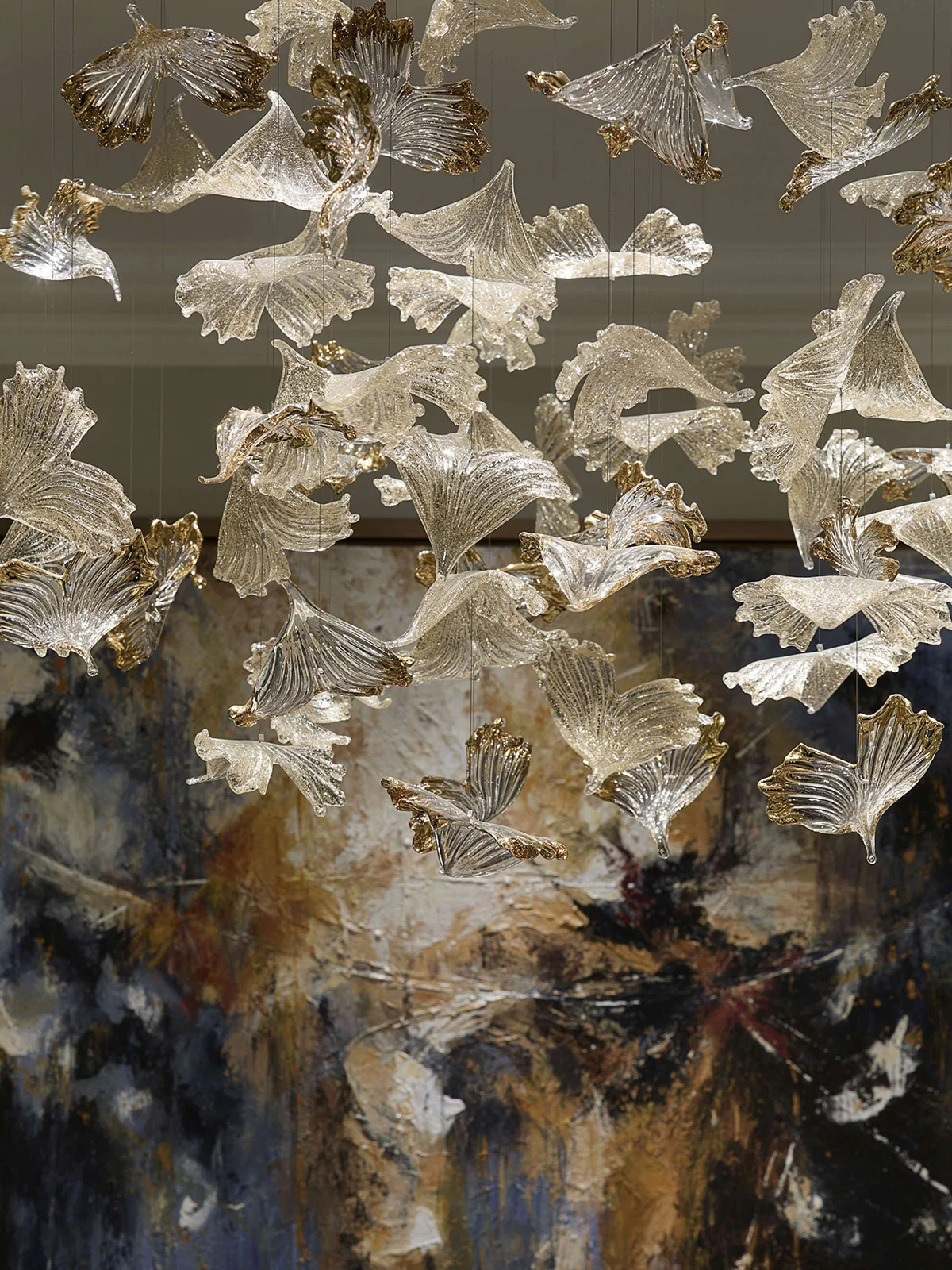 Bespoke sculptural glass chandelier installation suspended above an abstract artwork.